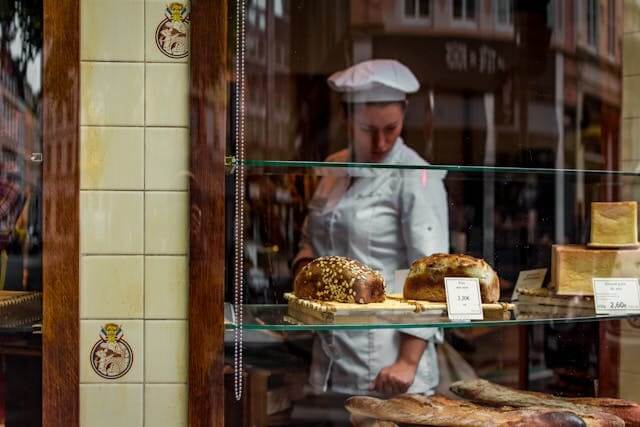 A baker in a bakery preparing bread, symbolising our German Short Story featuring Profession Vocabulary.