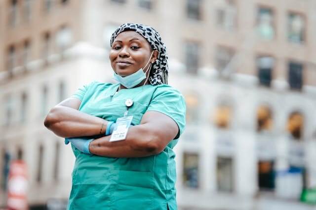 A confident nurse standing with arms crossed, symbolizing professions in daily life for the A1-A2 German Short Story Professions in Daily Life.