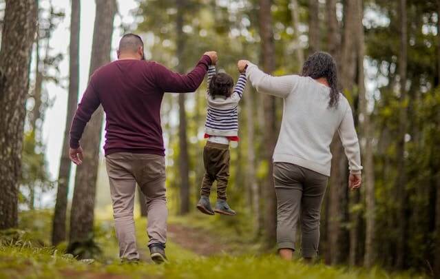 A family walking through a forest, symbolizing togetherness for the German Family Vocabulary Quiz.