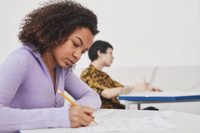 A female student is learning German dative prepositions.