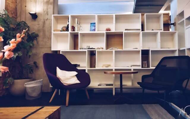 A modern living space showing shelves, armchairs, and a table, representing the German Furniture Vocabulary Quiz.