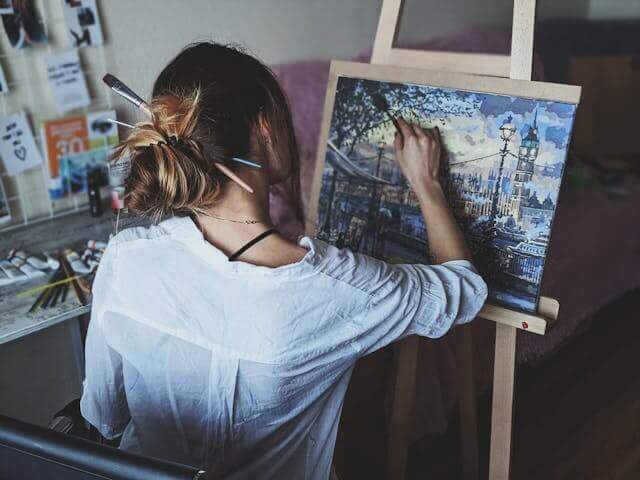 An artist painting on a canvas, showcasing the essence of German art and culture vocabulary.