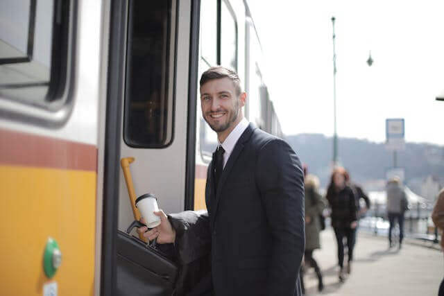 Businessman boarding a tram, ideal for learning German transportation vocabulary for urban travel.