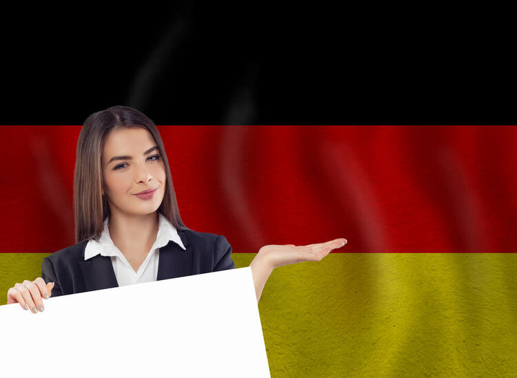 Confident woman presenting the concept of German Future 1 Tense against the backdrop of the German flag.