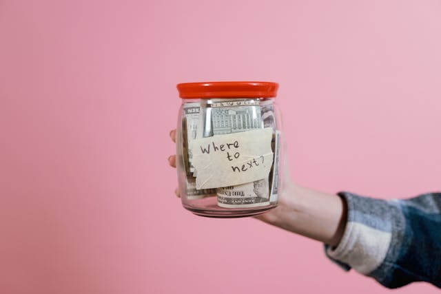 Money jar labeled 'Where to Next' representing German vocabulary for plans and wishes, such der Traum (dream).