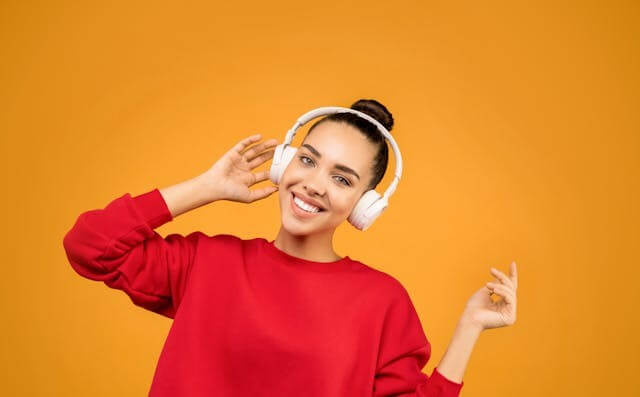 Woman listening to headphones symbolizing a German audio short story about traveling