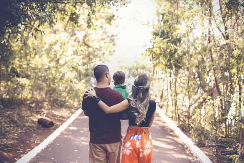 A family walking together in a serene forest - German Family Vocabulary.