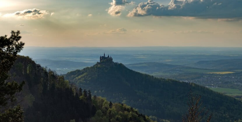 cenic view of a German castle on a hill, representing two-way prepositions in grammar.