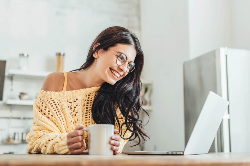 Woman learning German inversion online with enthusiasm.